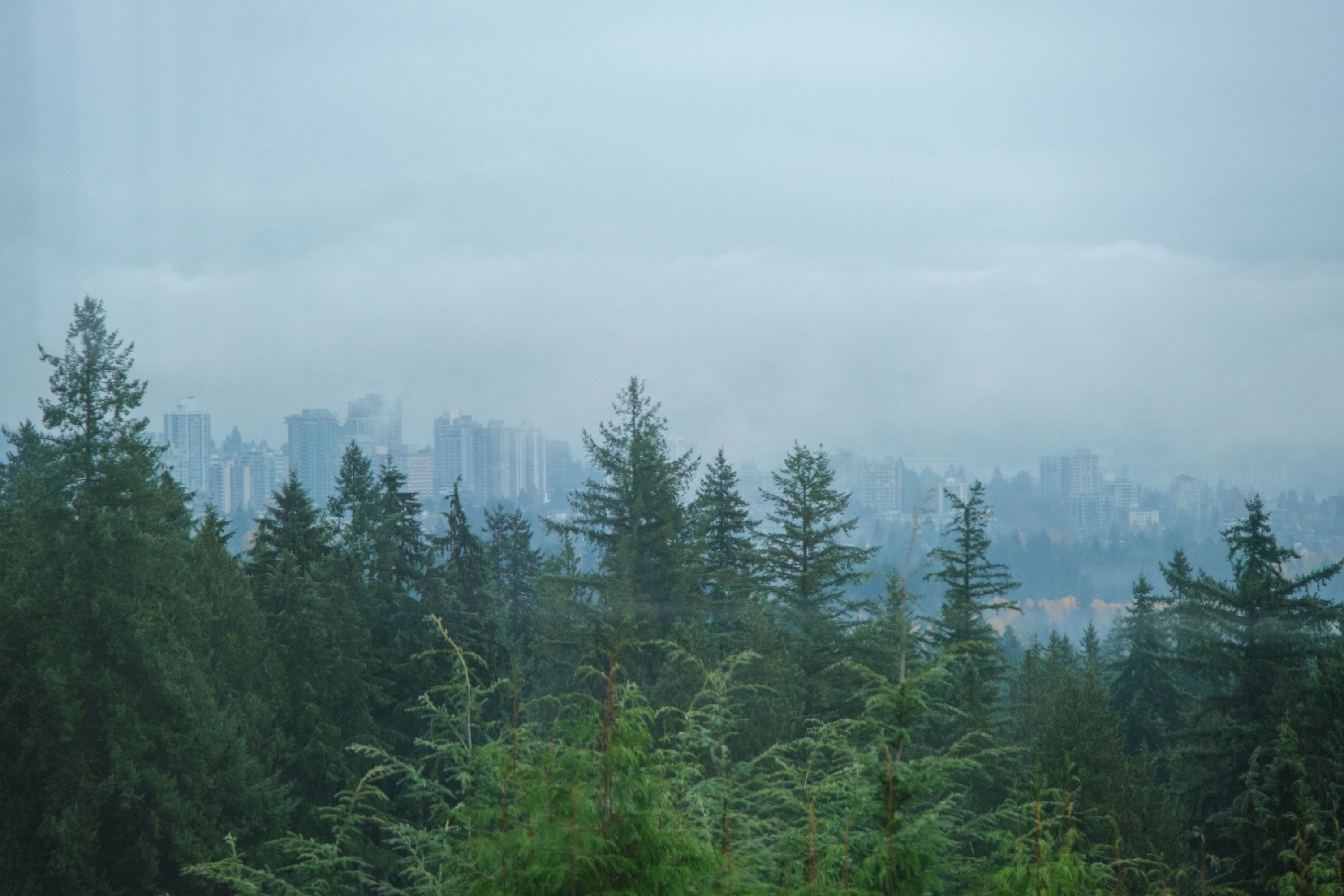 Downtown Vancouver peeking out from the fog, visible from North Vancouver.