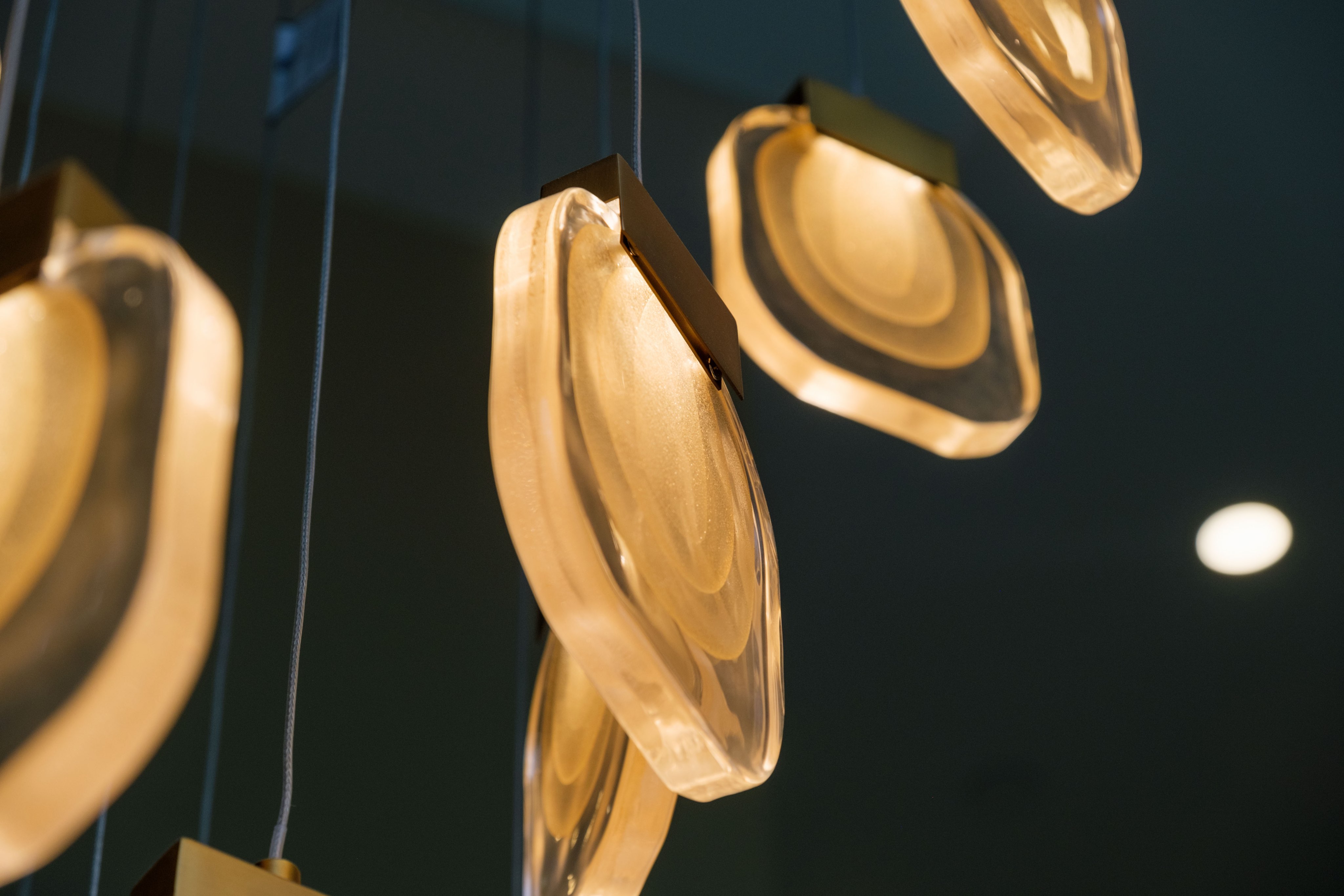 Beautiful lighting fixture around wrapping staircase.